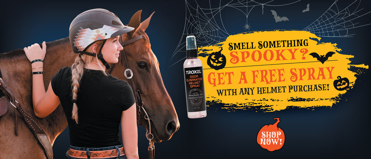 Troxel Halloween offer: Free Odor Eliminator Helmet Spray with any helmet purchase, featuring a rider wearing a patterned helmet beside a horse.