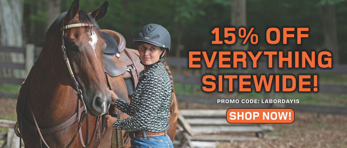 Woman wearing a Troxel riding helmet beside a saddled horse. Labor Day sale: 15% off sitewide with promo code LABORDAY15.
